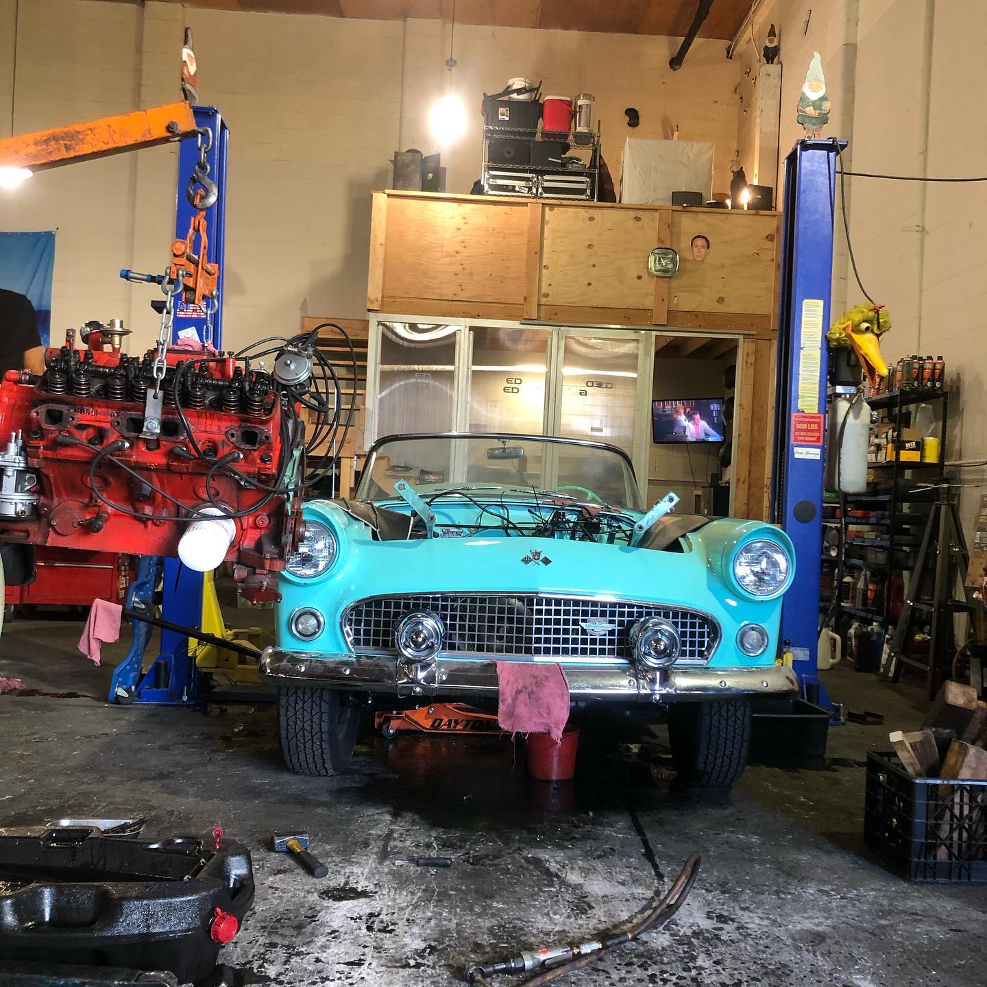 photo of a teal thunderbird being serviced